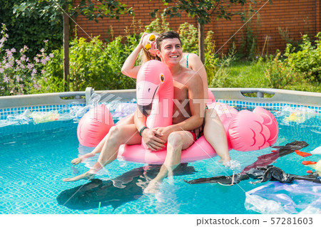 Problem of trash, plastic recycling, pollution and environmental concept - silly man and woman swim Problem of trash, plastic recycling, pollution and environmental concept - silly man and woman swim 57281603