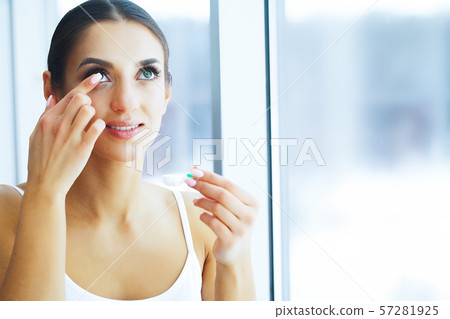 Health. Young Woman Apply Eye Drops. Fresh View. Portrait of a Beautiful Woman with Green Eyes. High 57281925