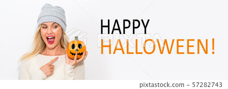 Happy Halloween with woman holding a pumpkin Happy Halloween with woman holding a pumpkin 57282743