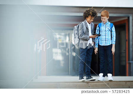 Children with phone outdoors Children with phone outdoors 57283425