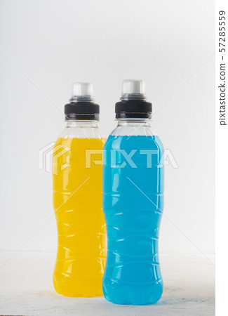 Isotonic energy drink. Bottles with blue and yellow transparent liquid, sport beverage on a white 57285559