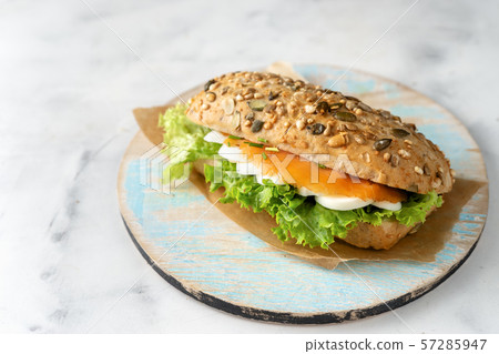 Healthy sandwich with salmon on white background 57285947