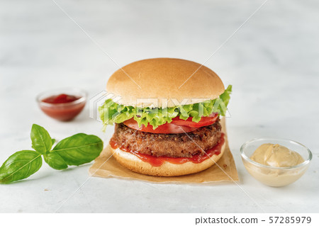 Homemade vegan burger on white rustic background Homemade vegan burger on white rustic background 57285979