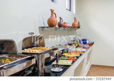 Hotel breakfast board in a family hotel. Buffet with different dishes. Hotel breakfast board in a family hotel. Buffet with different dishes. 57287444