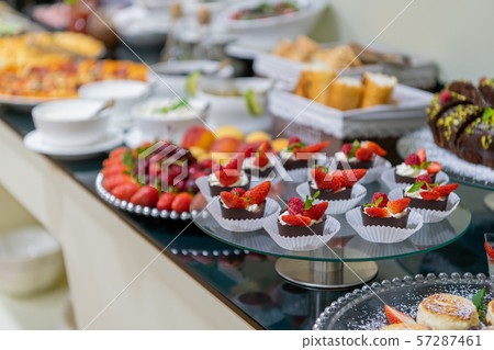 A tasty sweet dessert with creme and strawberries on a breakfast buffet at a hotel. 57287461