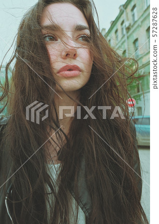 Sensual wrinkled good looking girl posing with windy hair ouside, sunflares of wide angle smartphone Sensual wrinkled good looking girl posing with windy hair ouside, sunflares of wide angle smartphone 57287628