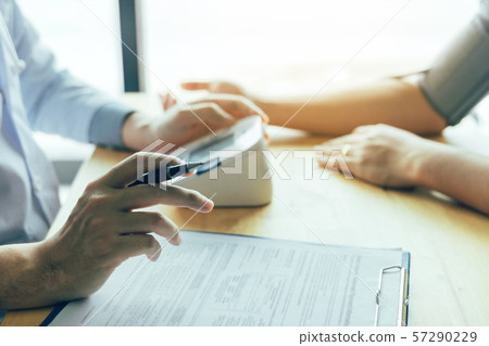 Doctor is using a pulse meter to measure the 57290229