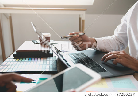 Two business partnership coworkers discussing a 57290237