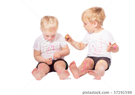 Children draw colored chalk on each other 57291599