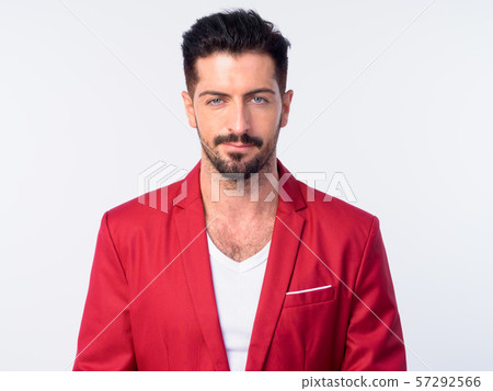 Face of young handsome bearded businessman in red suit 57292566