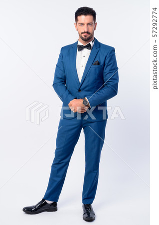 Full body shot of young handsome bearded businessman in blue suit 57292774