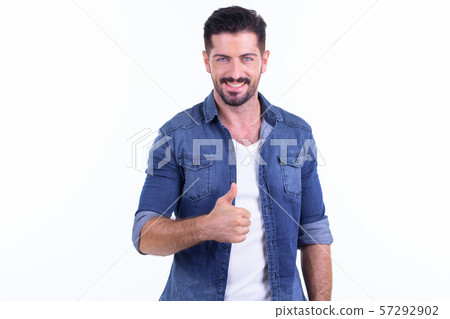 Happy young bearded hipster man giving thumbs up 57292902