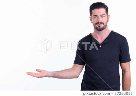 Portrait of young handsome bearded man showing something 57293035