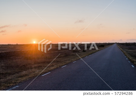 Sunrise by a straight country road in a great 57294286