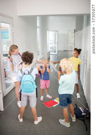 Older pupils bullying poor younger girl while pilling her hair Older pupils bullying poor younger girl while pilling her hair 57305877