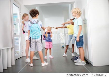 Rude pupils bullying poor little girl in the corridor 57306037