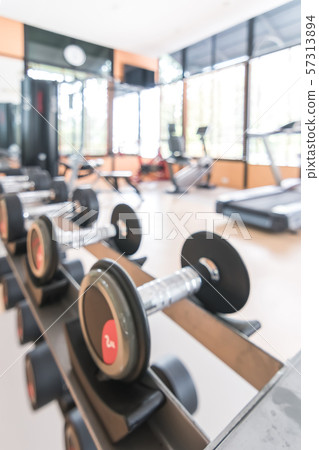 Blur gym background fitness center or health club with blurry sports exercise equipment for aerobic workout and bodybuilding Blur gym background fitness center or health club with blurry sports exercise equipment for aerobic workout and bodybuilding 57313894