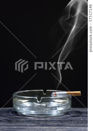 Cigarette on transparent ashtray Cigarette on transparent ashtray 57317146