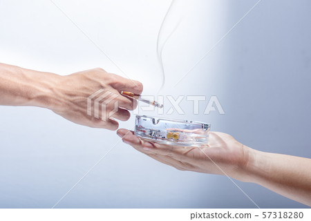 Man hand give a transparent ashtray to smoker 57318280