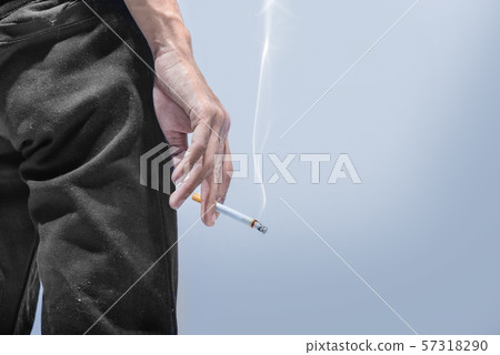 Man standing with a cigarette on his hand 57318290