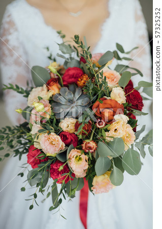 bride in a white dress holding a bouquet of flowers and greenery bride in a white dress holding a bouquet of flowers and greenery 57325252