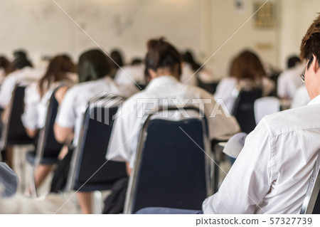 Blur school background university students writing answer doing exam in classroo Blur school background university students writing answer doing exam in classroo 57327739