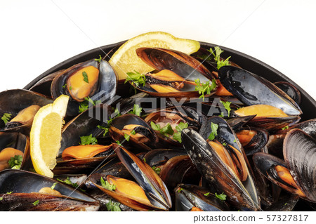 Marinara mussels, moules mariniere, close-up in a cooking pan on a white background with a place for 57327817