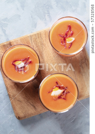Salmorejo, Spanish cold tomato and bread soup, served in glasses, overhead close-up shot with a 57328568