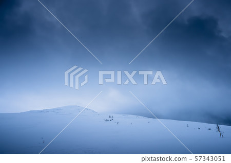Snow covered Storsteinen mountain summit 57343051