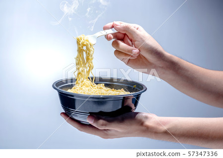 People eat the noodles with fork People eat the noodles with fork 57347336