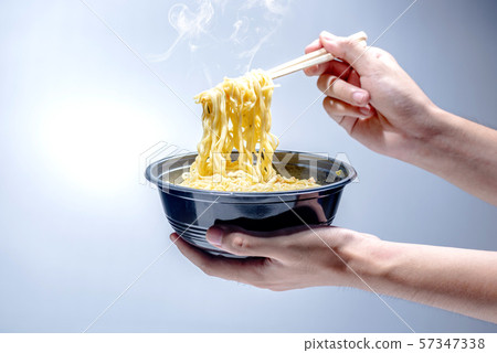 People eat the noodles with chopstick People eat the noodles with chopstick 57347338