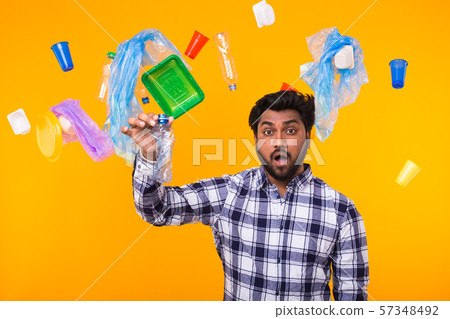 Problem of trash, plastic recycling, pollution and environmental concept - surprised Indian man Problem of trash, plastic recycling, pollution and environmental concept - surprised Indian man 57348492