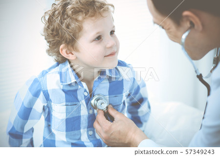 Doctor and patient child. Physician examining little boy. Regular medical visit in clinic. Medicine 57349243