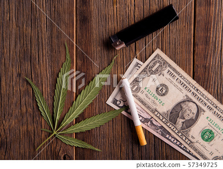 Cannabis leaves on a wooden table. 57349725