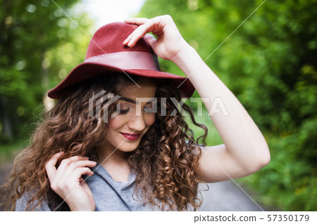 Close-up portrait of young woman traveller standing in nature. Close-up portrait of young woman traveller standing in nature. 57350179