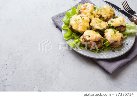 Champignon mushrooms stuffed with cheese,chicken and herbs baked in oven Champignon mushrooms stuffed with cheese,chicken and herbs baked in oven 57350734
