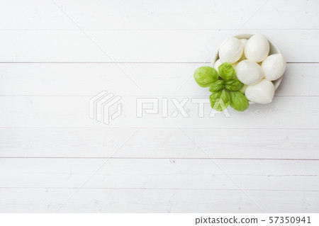 Mozzarella balls and Basil in the dish, selective focus Copy space Mozzarella balls and Basil in the dish, selective focus Copy space 57350941