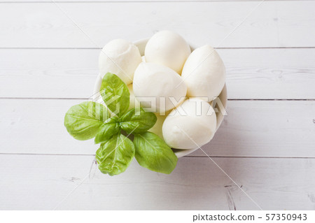 Mozzarella balls and Basil in the dish, selective focus Copy space Mozzarella balls and Basil in the dish, selective focus Copy space 57350943