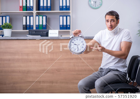 Young man at hospital reception desk 57351920