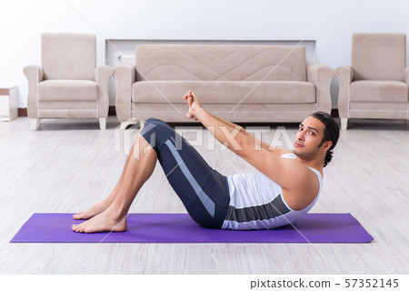 Young man training and exercising at home Young man training and exercising at home 57352145