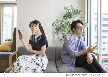 Men and women with their smartphones facing the opposite direction 57352158