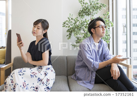 Men and women facing their opposite direction with their smartphones 57352161