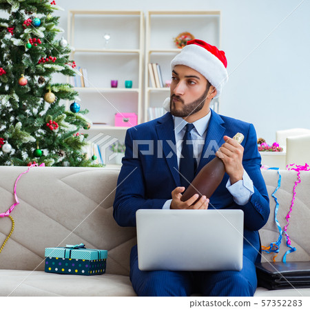 Businessman working at home during christmas 57352283