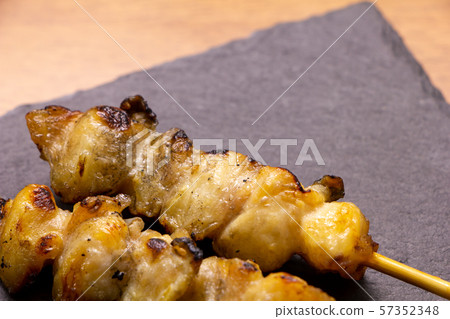 Yakitori and bonjiri skewers (salt grilled). On the slate plate. 57352348