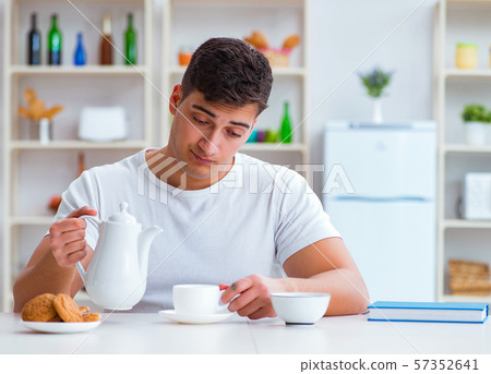 Man falling asleep during his breakfast after overtime work Man falling asleep during his breakfast after overtime work 57352641