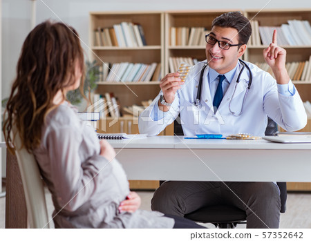Pregnant woman visiting doctor for consultation 57352642