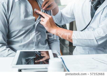 Doctor Measuring arterial blood pressure man Doctor Measuring arterial blood pressure man 57352668
