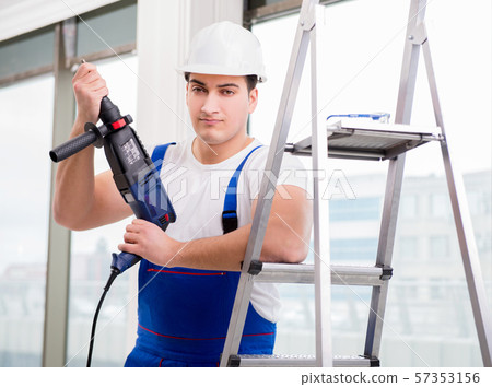 Repairman working with power drill in workshop Repairman working with power drill in workshop 57353156