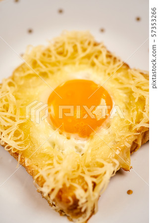 Delicious toast with fried egg on wooden kitchen table Delicious toast with fried egg on wooden kitchen table 57353266