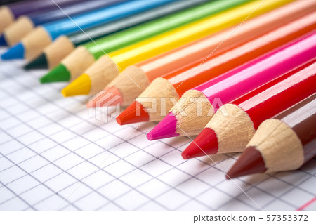 colored pencil crayons on an open checkered notebook colored pencil crayons on an open checkered notebook 57353372